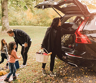 Family having a picnic by their car